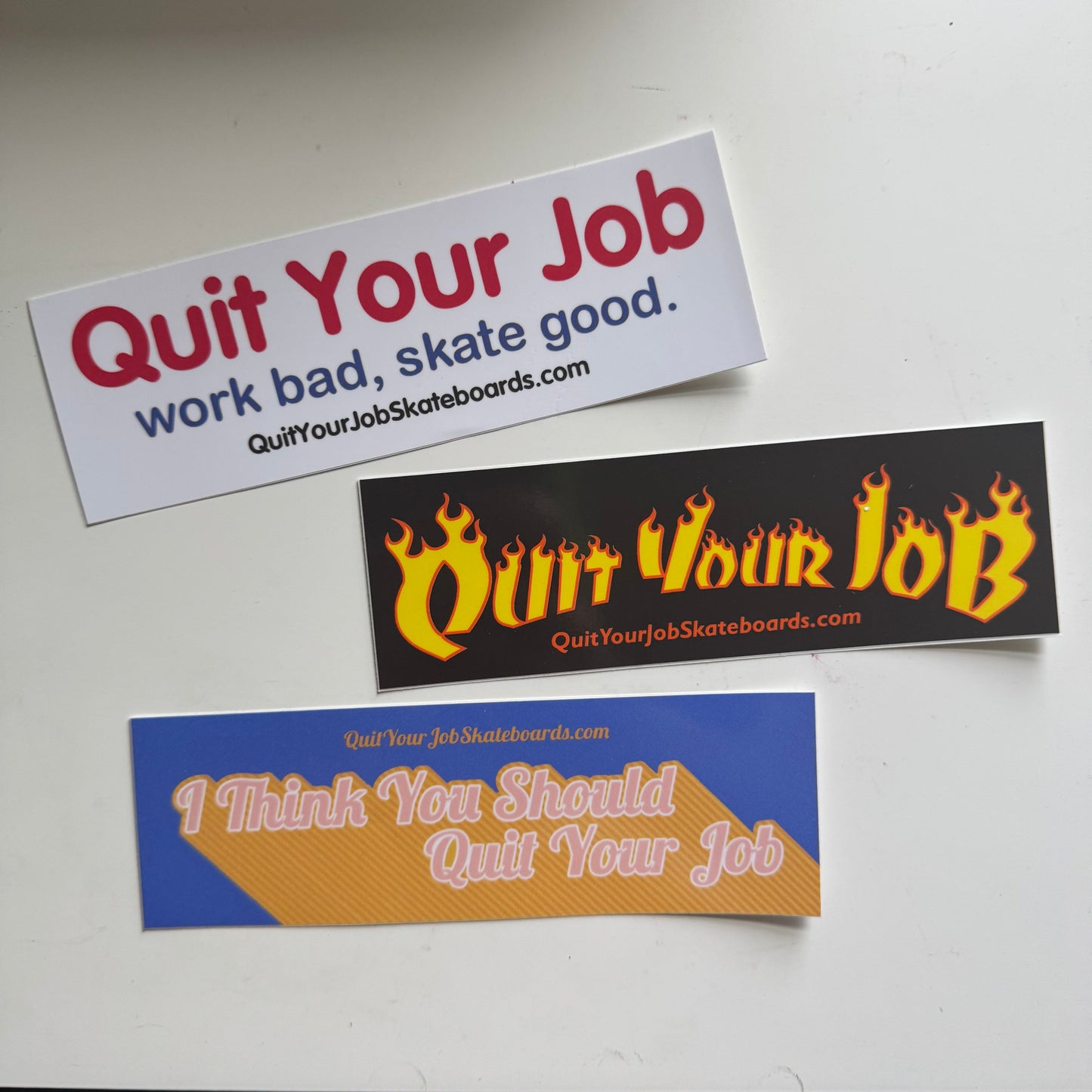 Three 'Quit Your Job' themed stickers on a white background
